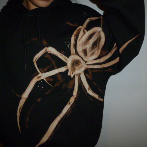 Black hoodie with a large bleach hand painted spider design.