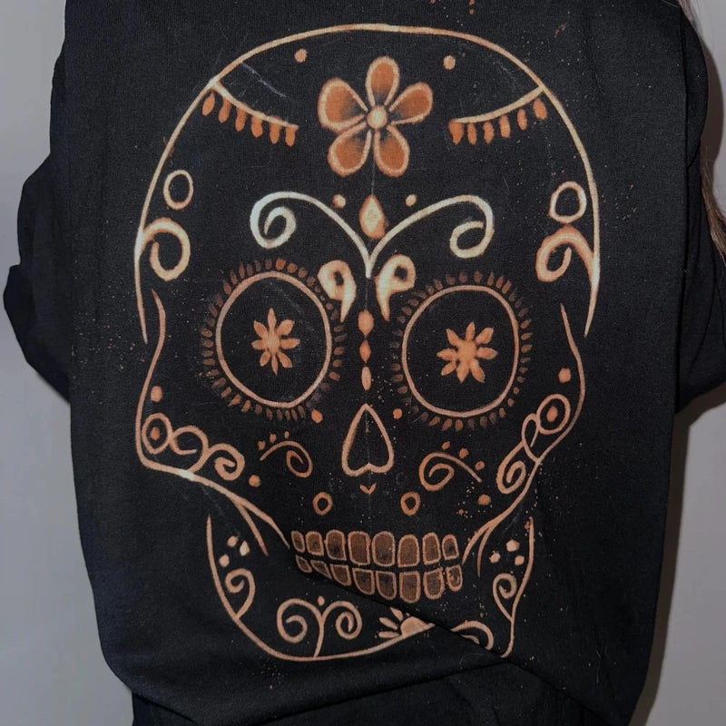 Black shirt with a decorative skull design on a plain background. Custom Clothing Portugal 