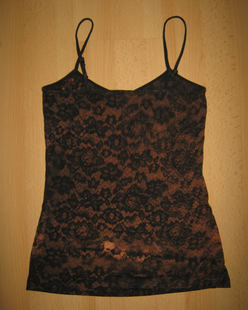 Black lace camisole on a wooden background