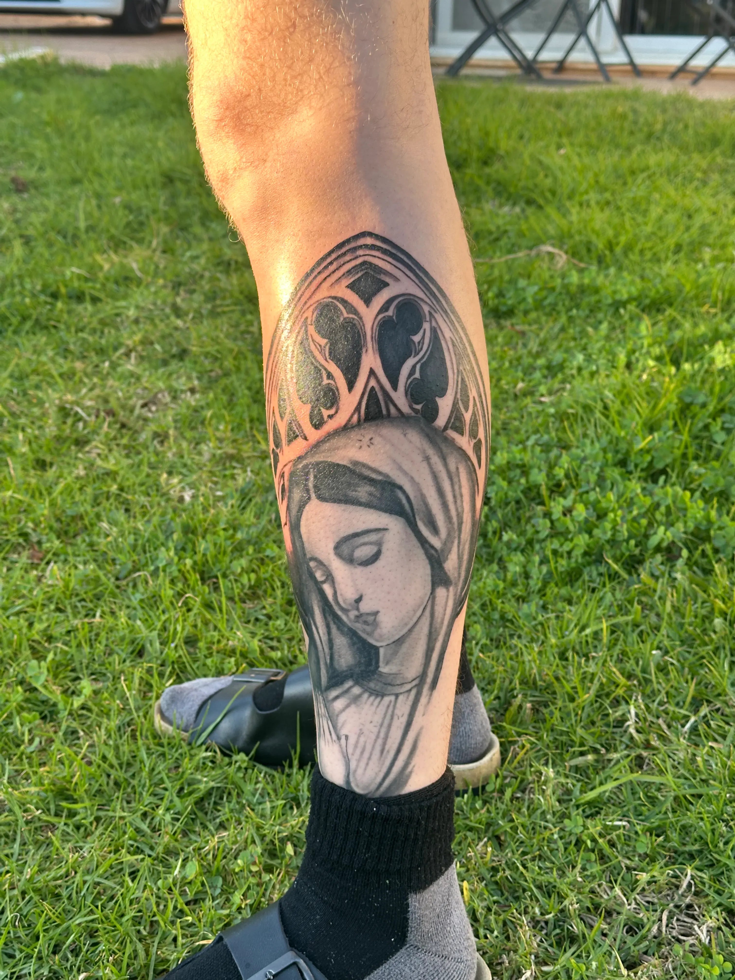 Tattoo of mother Mary and cathedral window